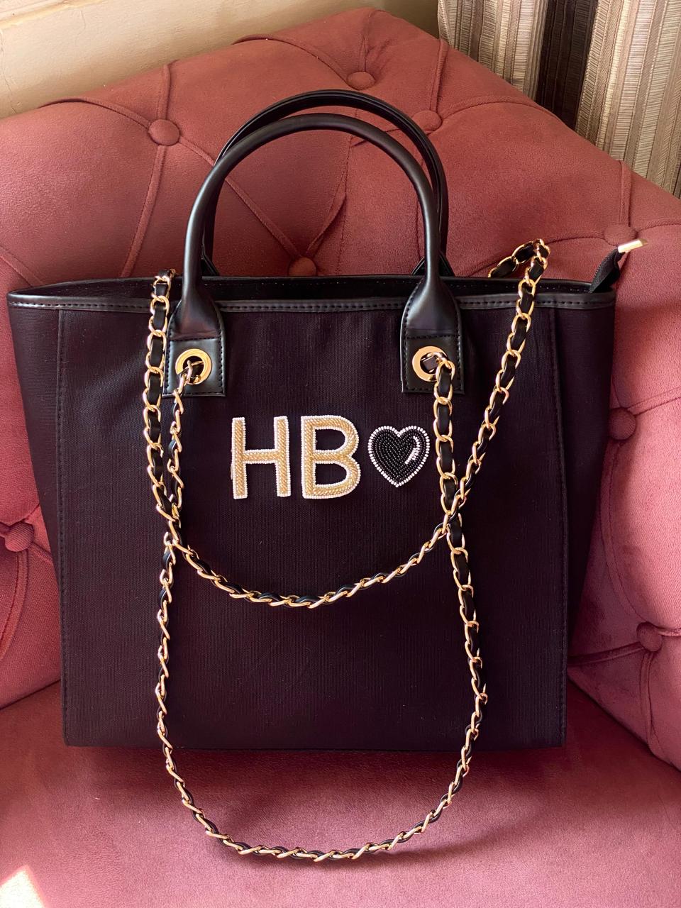 Black canvas tote bag with black heart charm