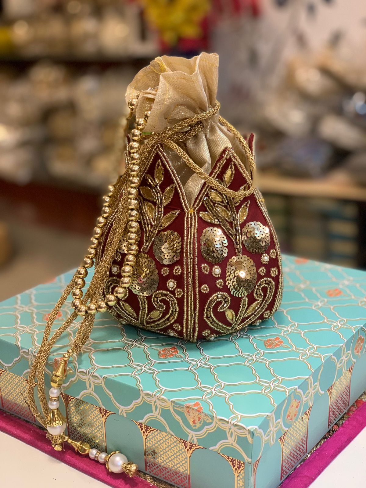 Maroon kalash shape potli with kundan work