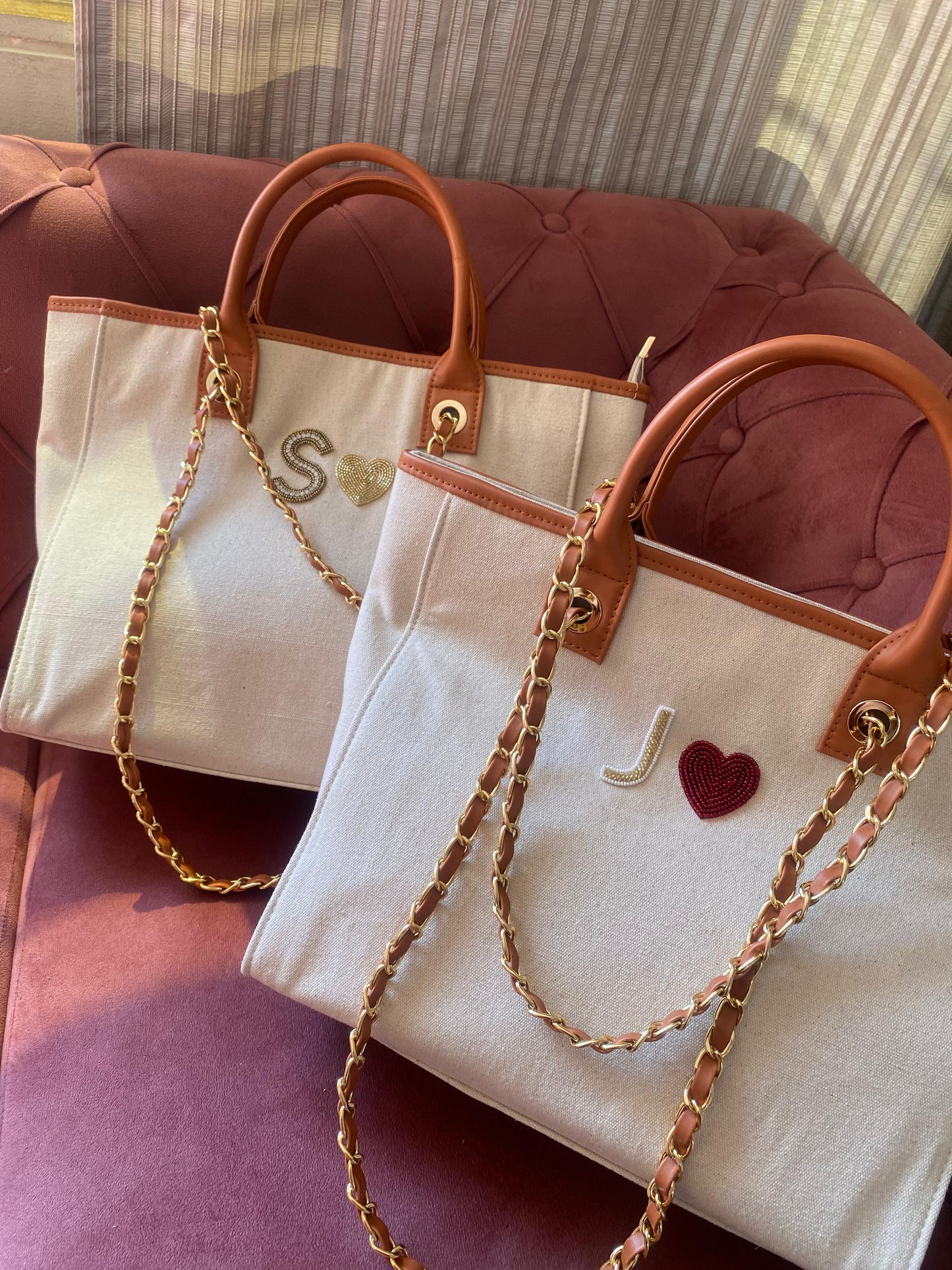 Beige canvas tote bag with golden heart charm