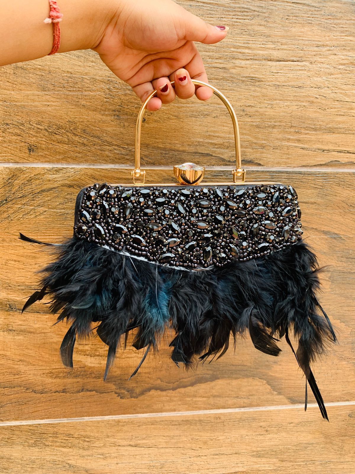 Feather work clutch with golden handle