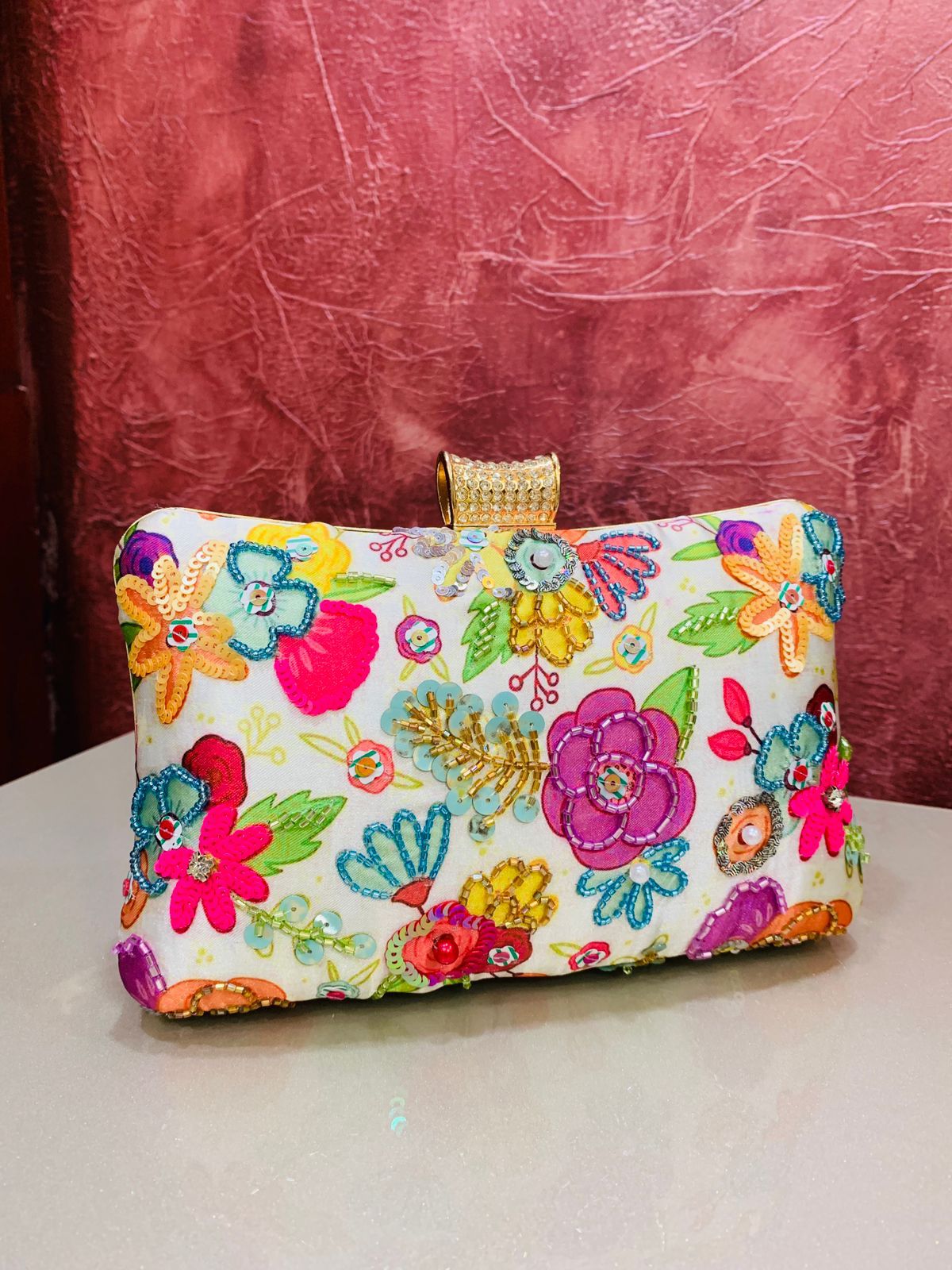 Multi color printed clutch with embroidery work
