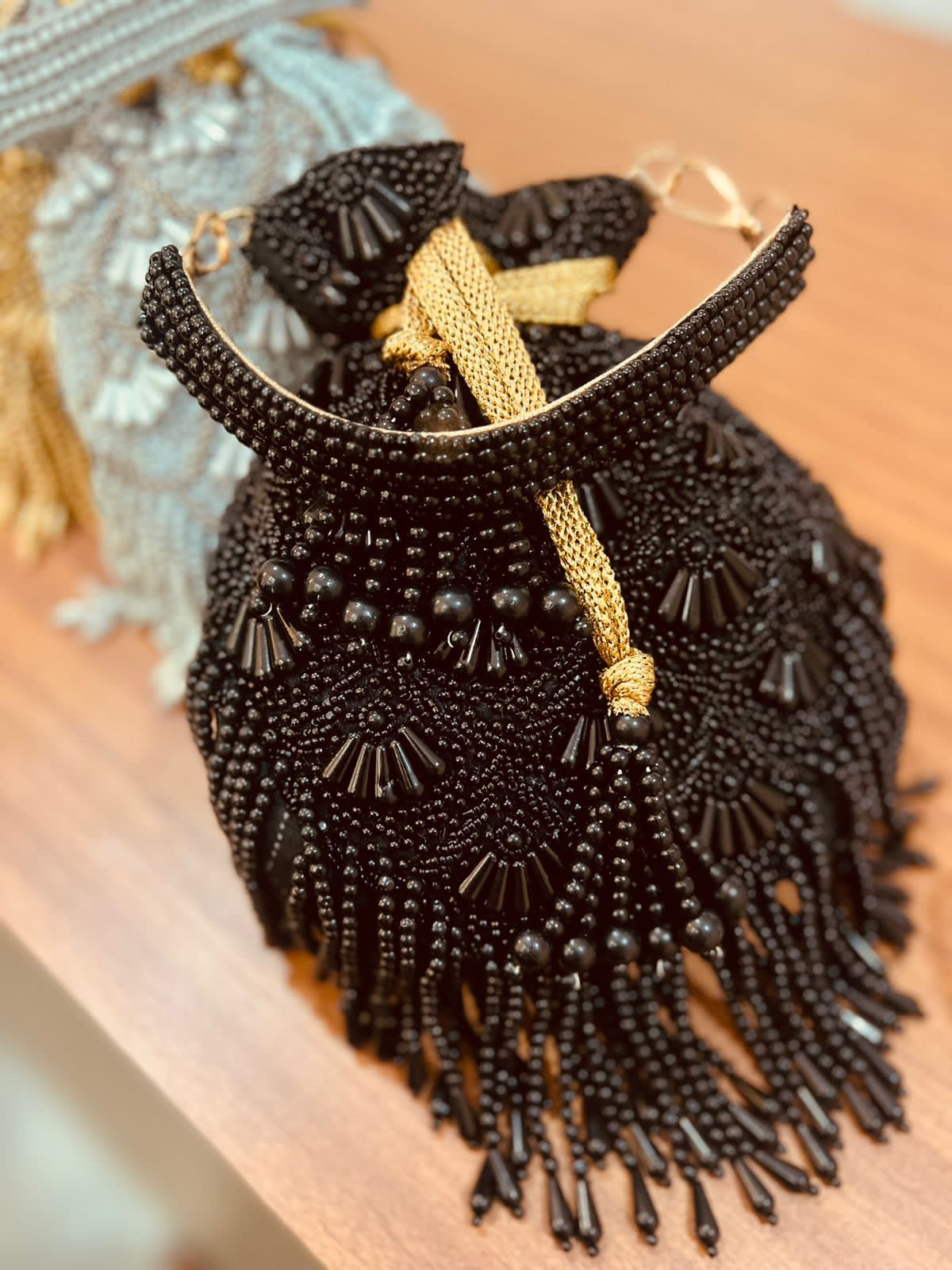 Bead work potli with pearl handle