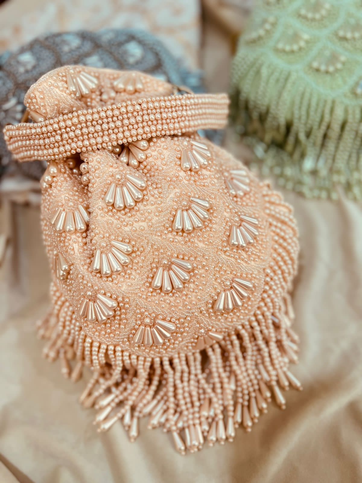 Bead work potli with pearl handle