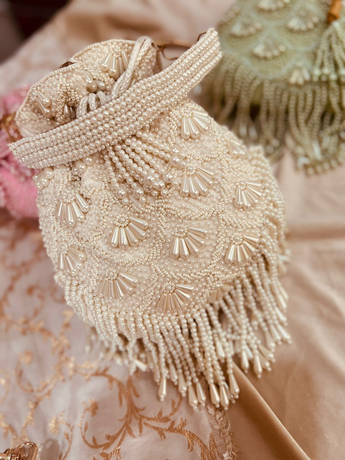 Bead work potli with pearl handle