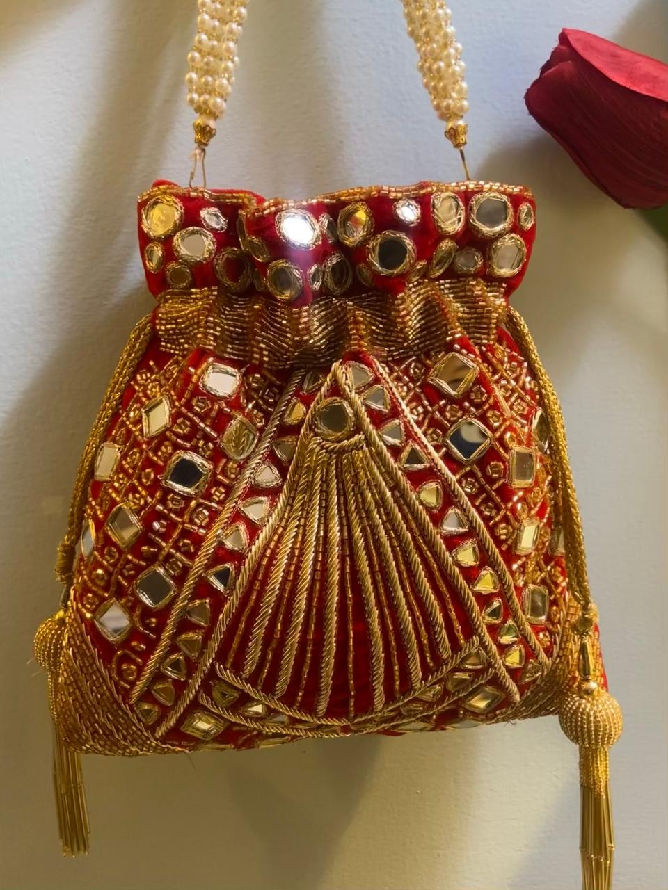 Red potli bag with golden thread and mirror work