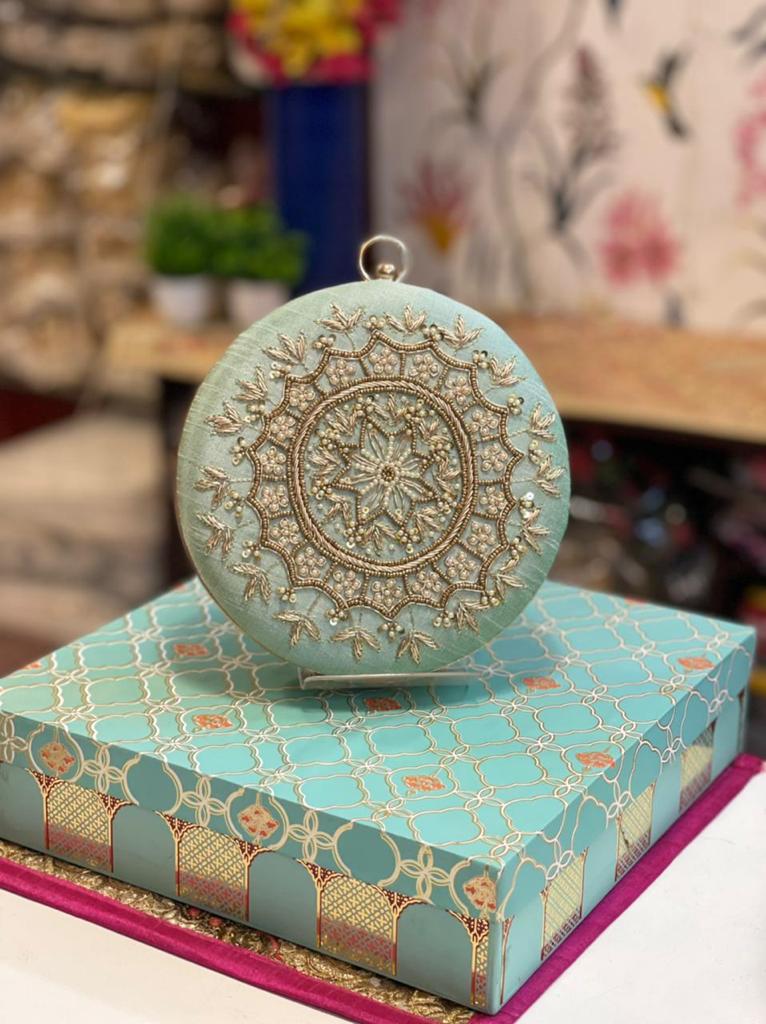Round embroidered clutch with golden work