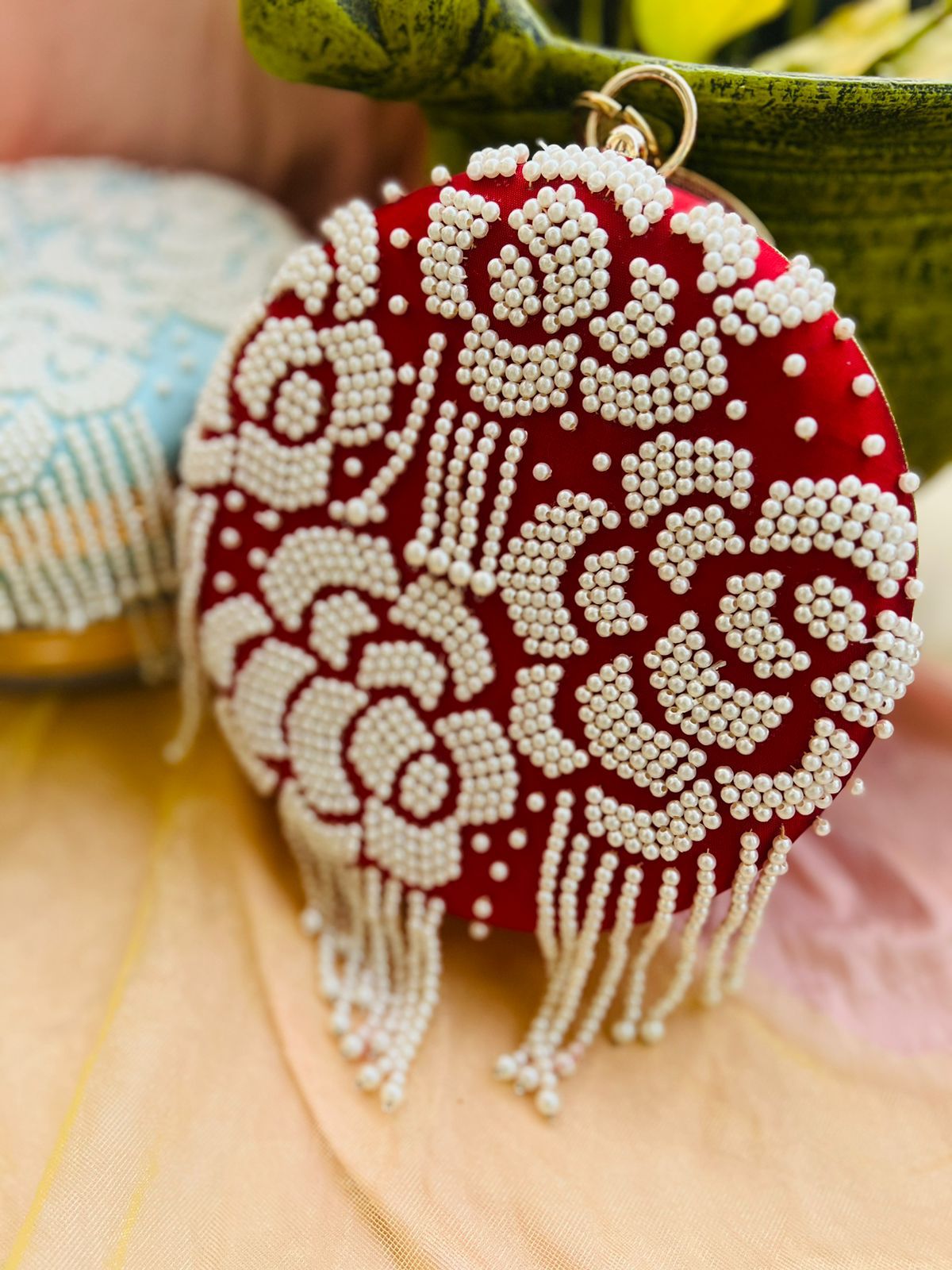 Round clutch with pearl work and latkans