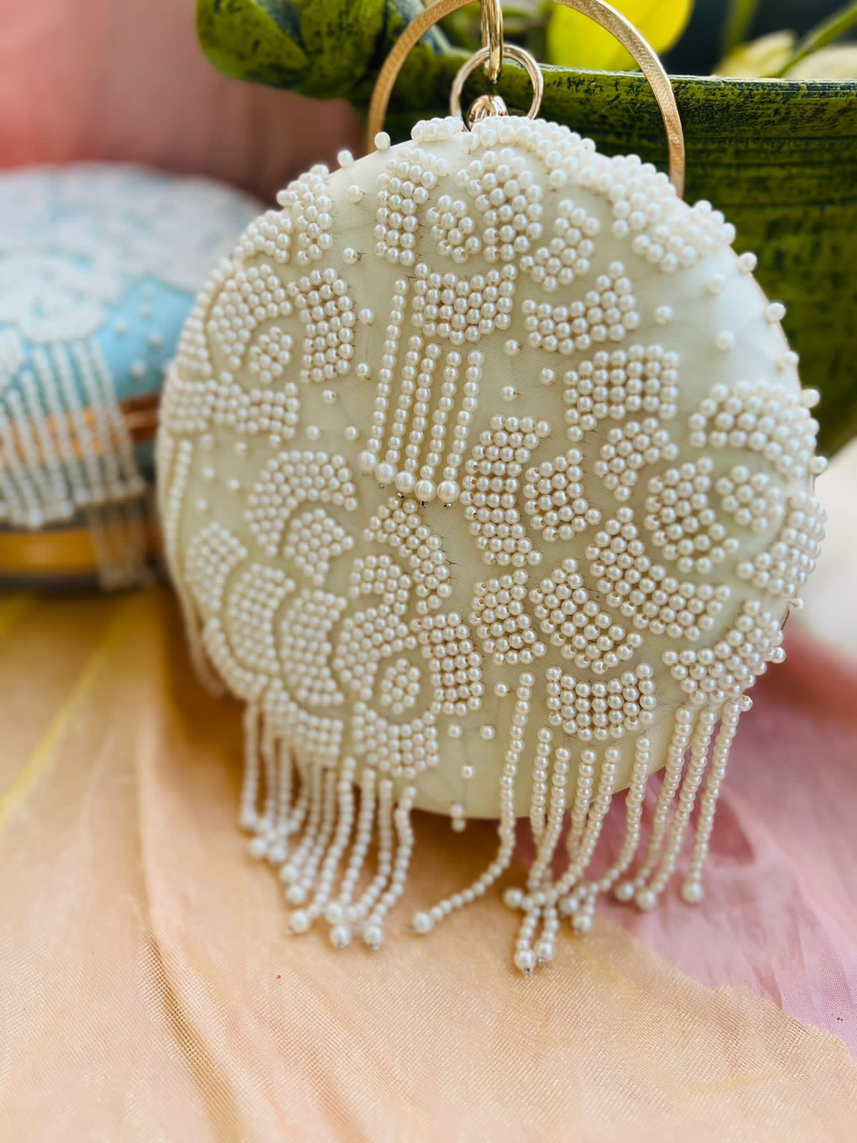 Round clutch with pearl work and latkans