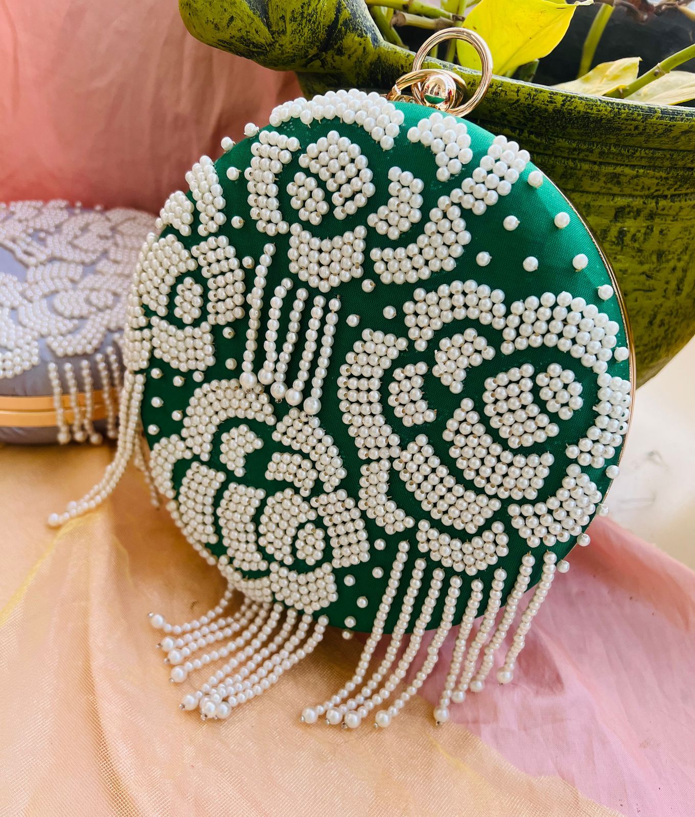 Round clutch with pearl work and latkans