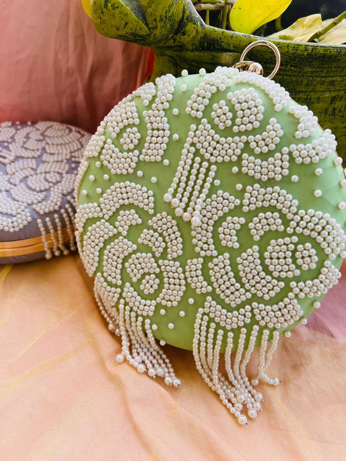 Round clutch with pearl work and latkans