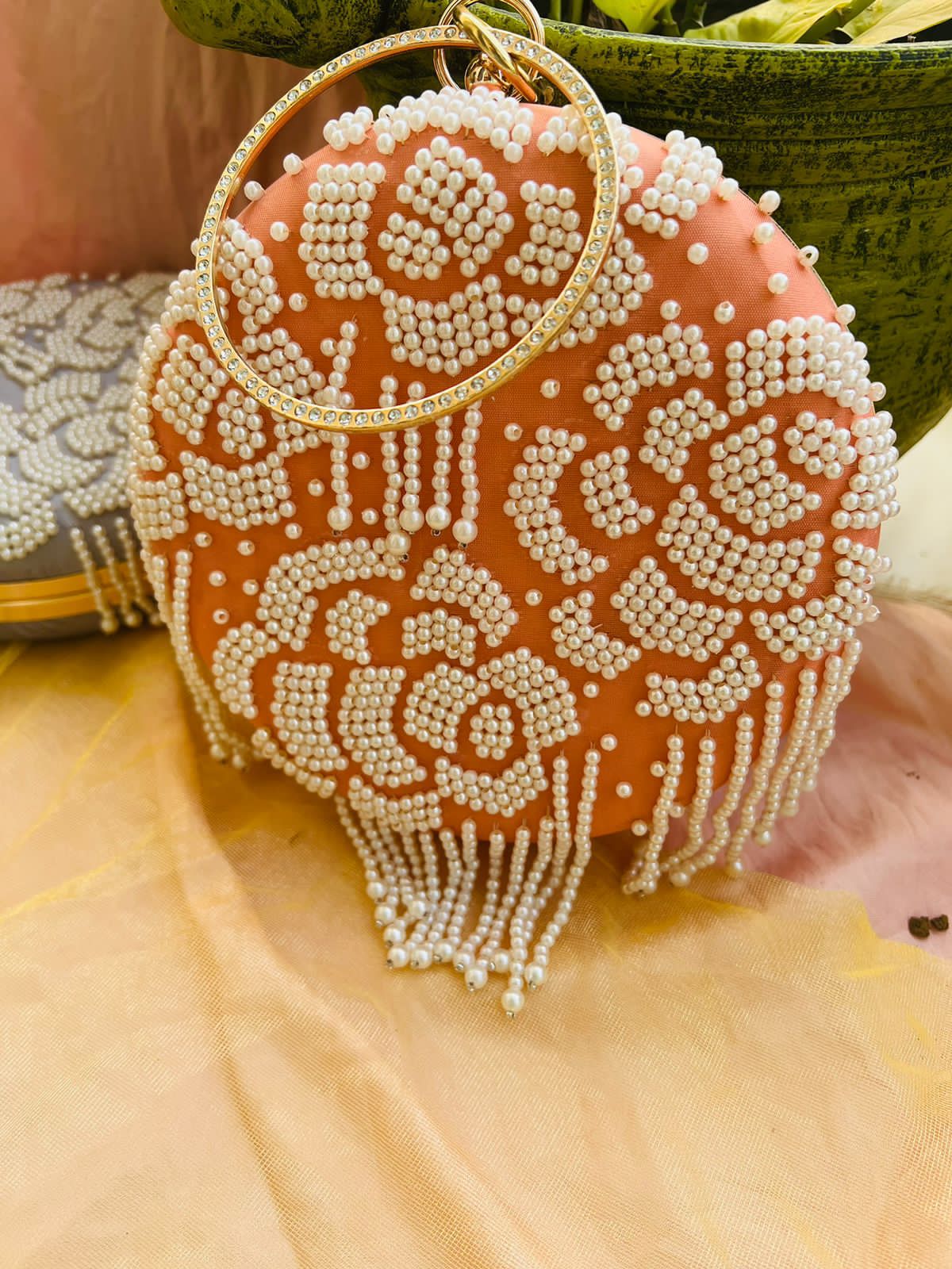 Round clutch with pearl work and latkans