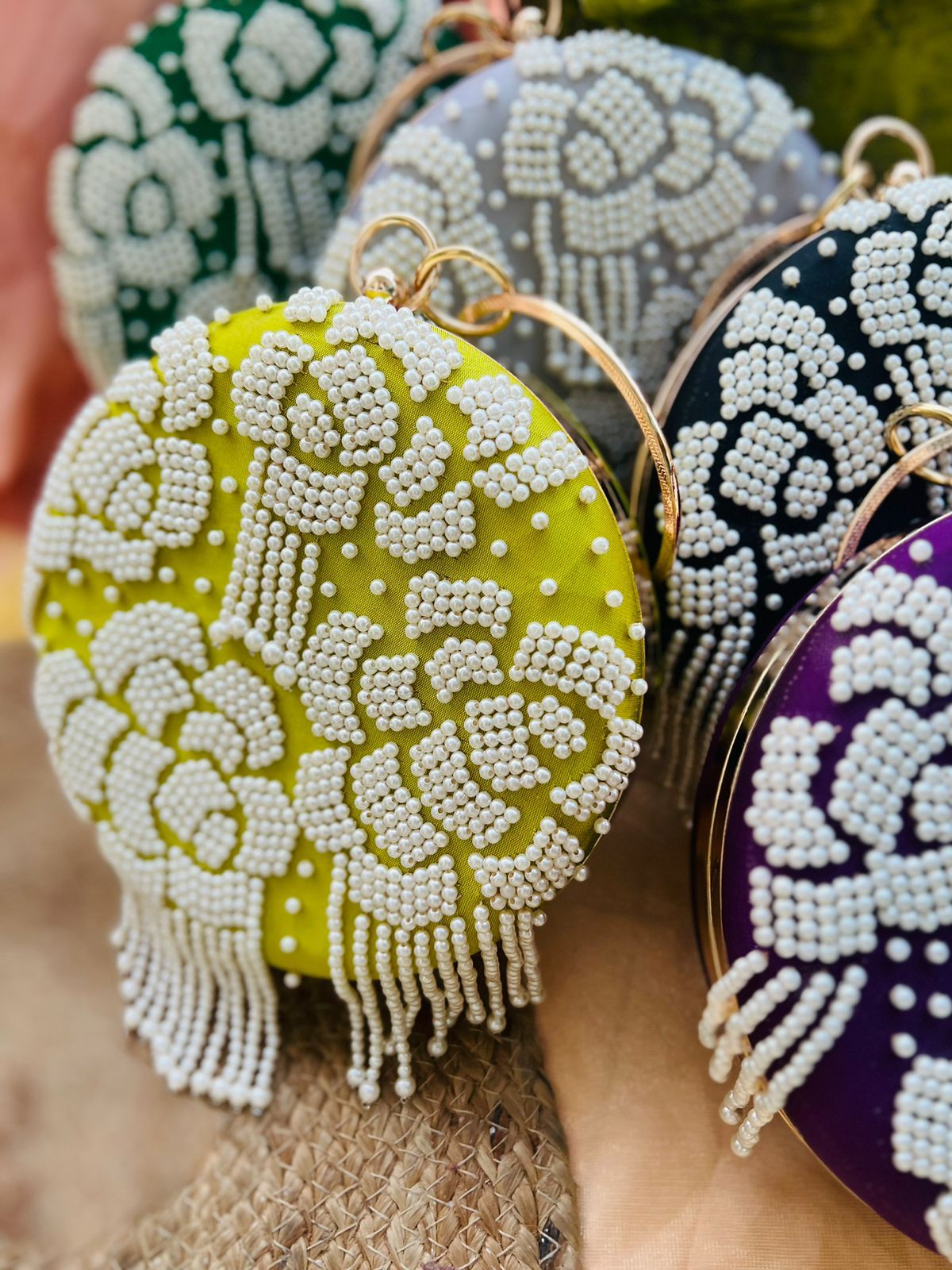 Round clutch with pearl work and latkans