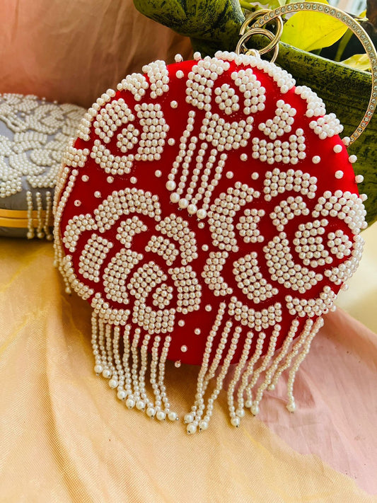 Round clutch with pearl work and latkans