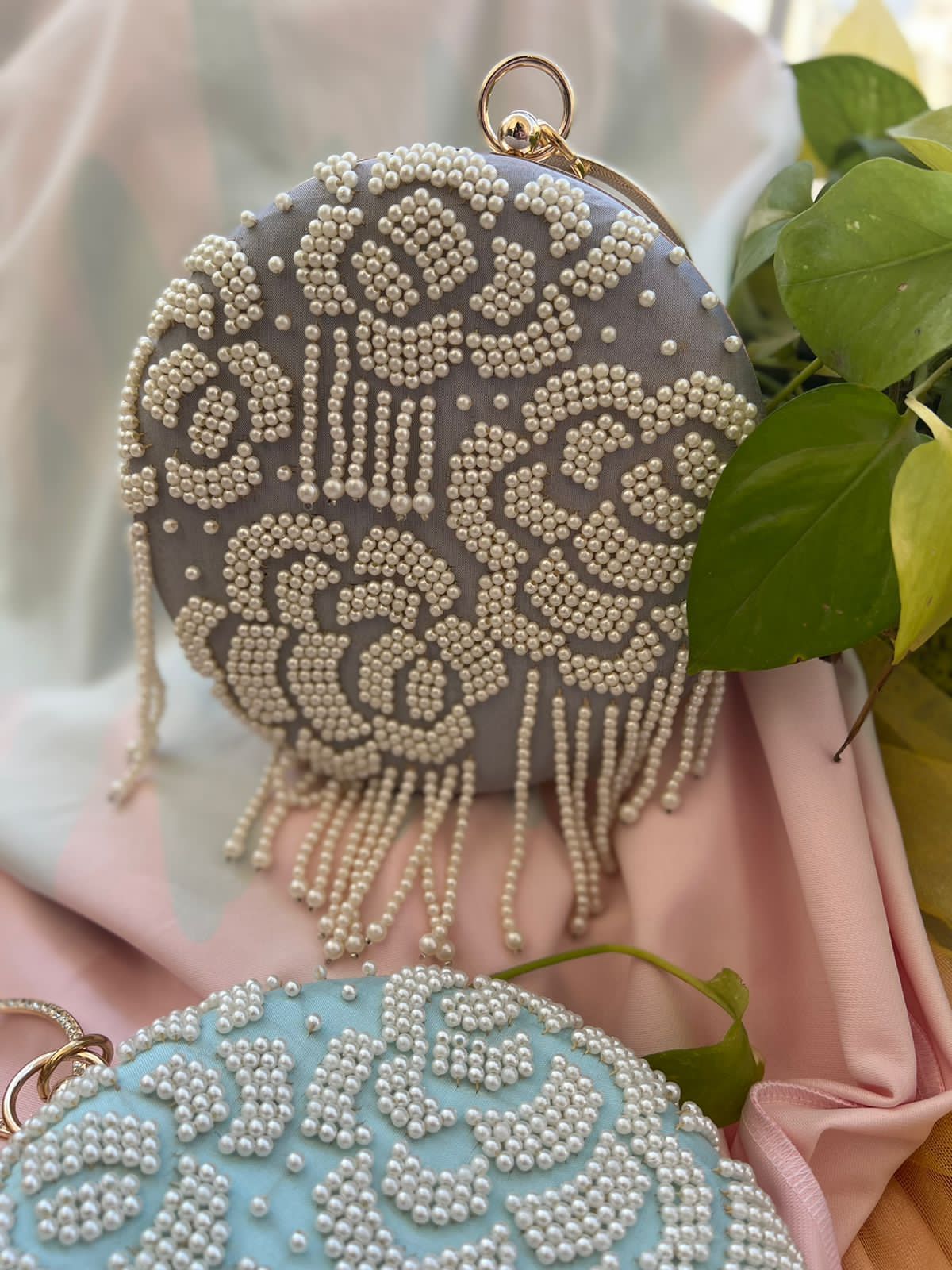 Round clutch with pearl work and latkans