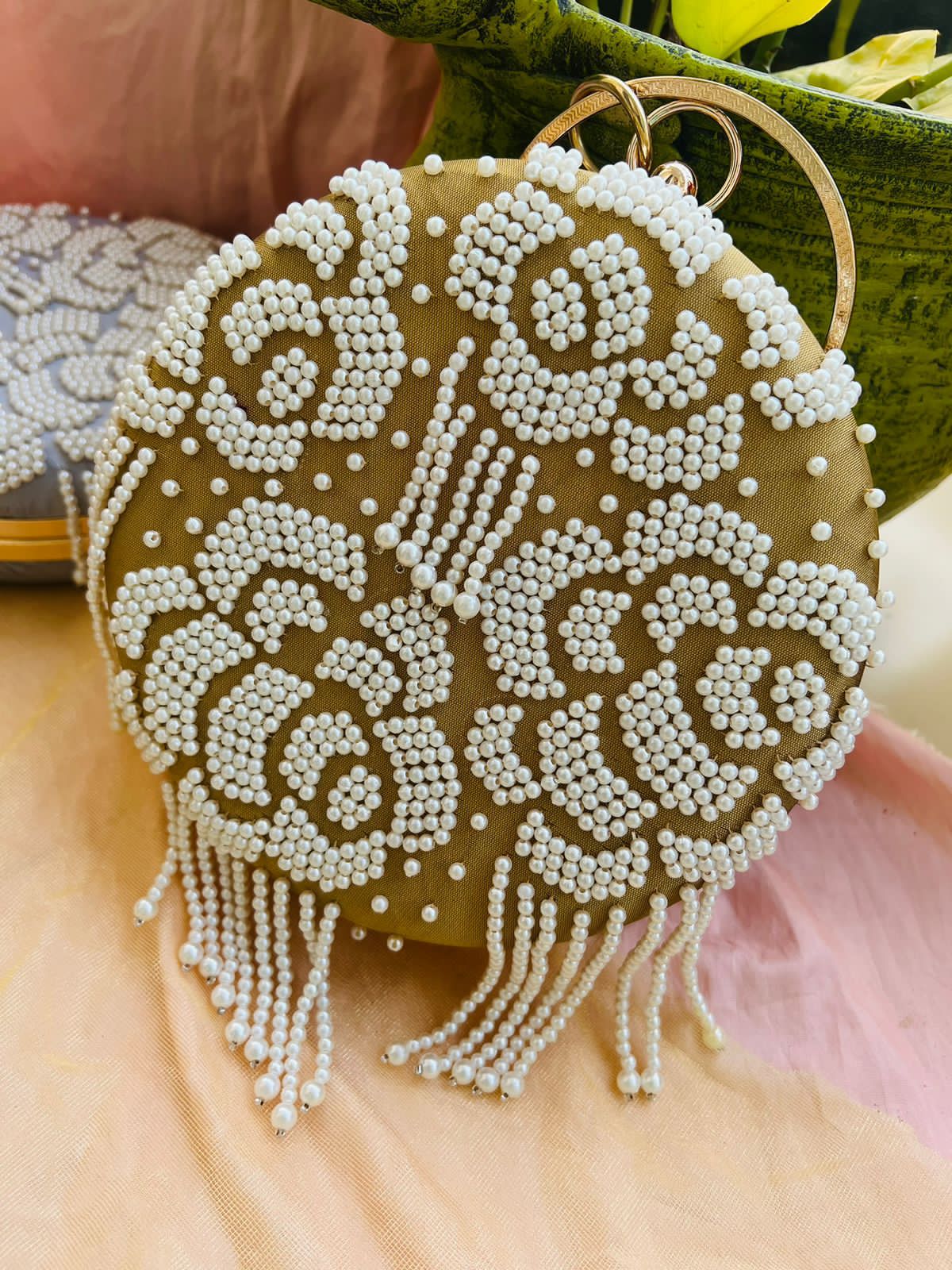 Round clutch with pearl work and latkans