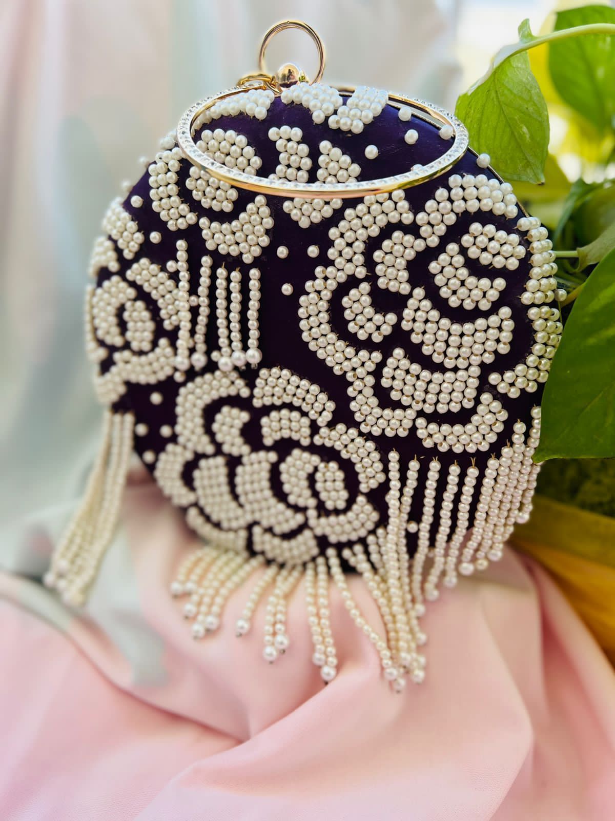 Round clutch with pearl work and latkans