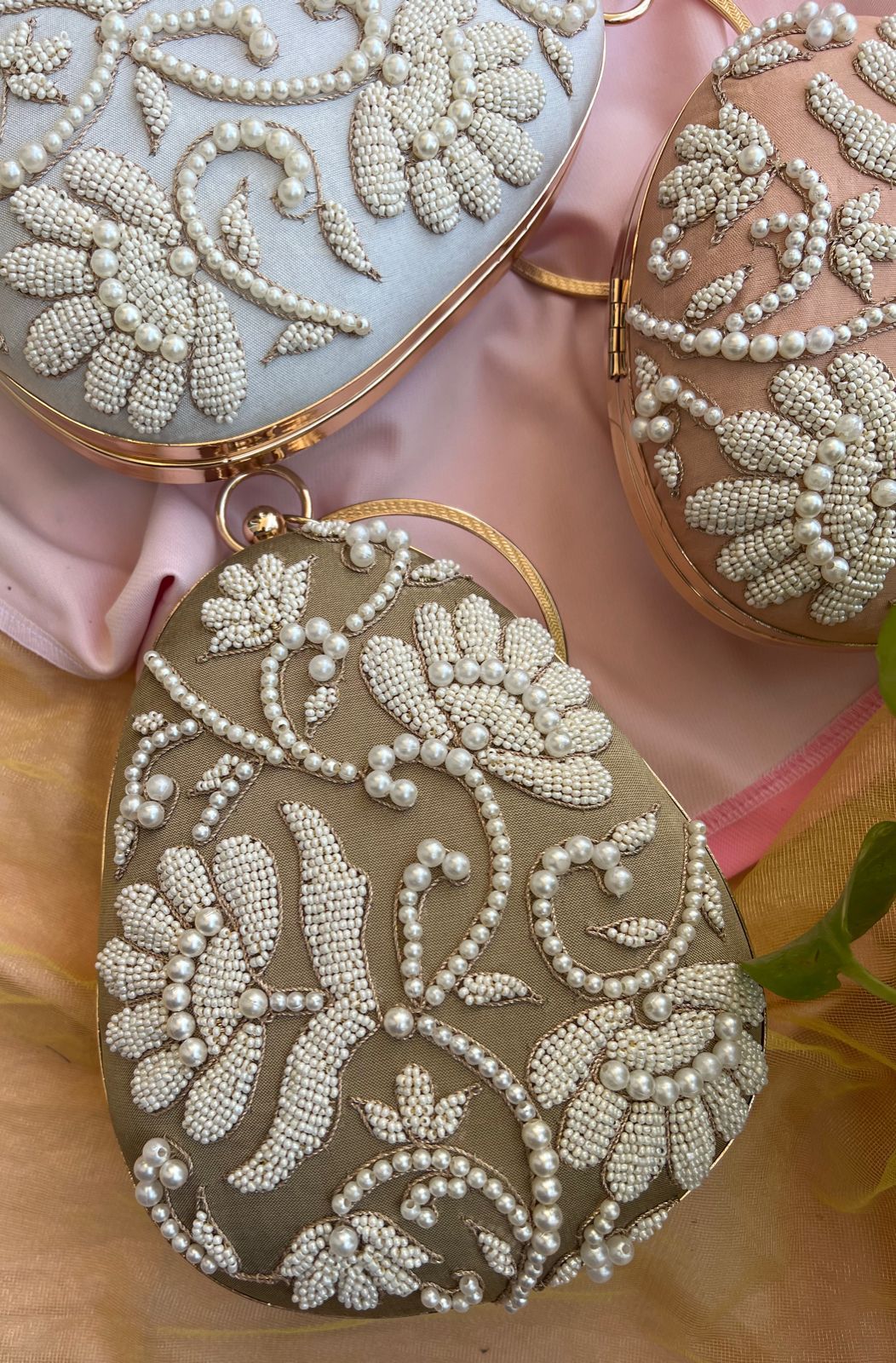 Oval clutch with pearl work and bangle
