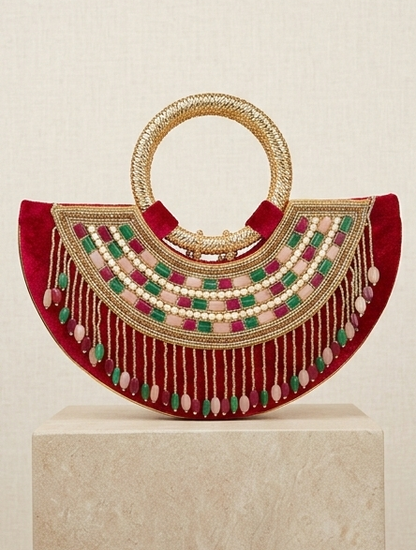 Moon clutch with golden handle and tassels