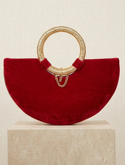 Moon clutch with golden handle and tassels