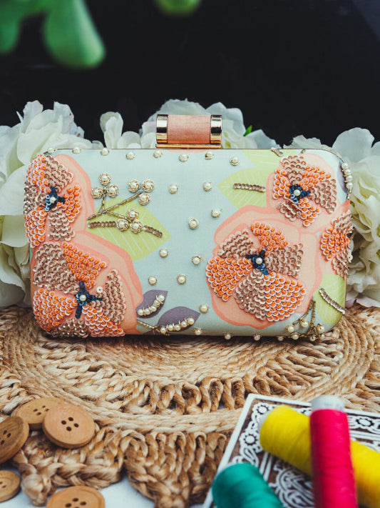 Mint green printed clutch with peach embroidery work