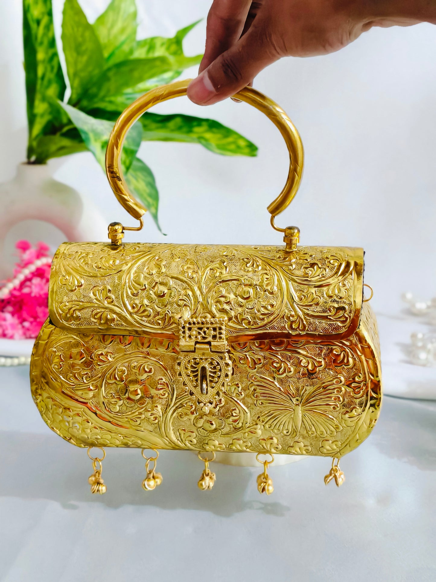 Golden color brass clutch with ghungroo