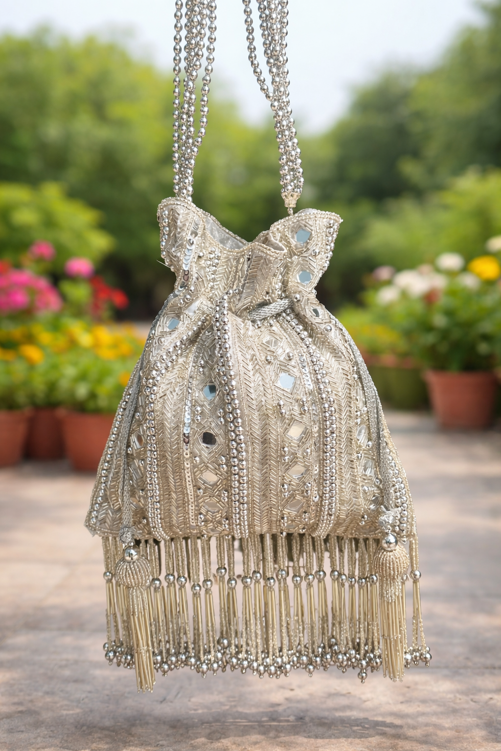 Ornate silver potli with beadwork