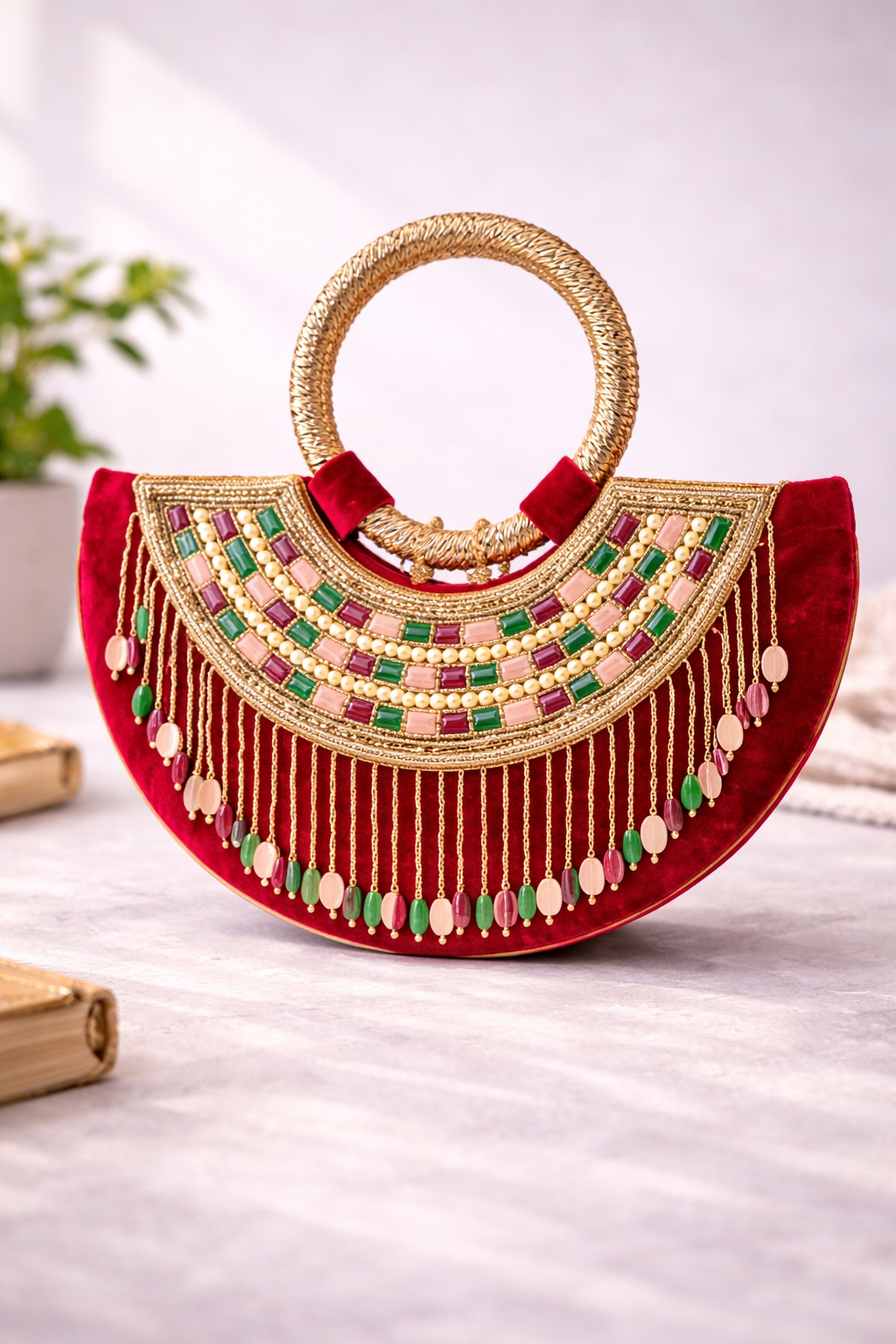 Moon clutch with golden handle and tassels