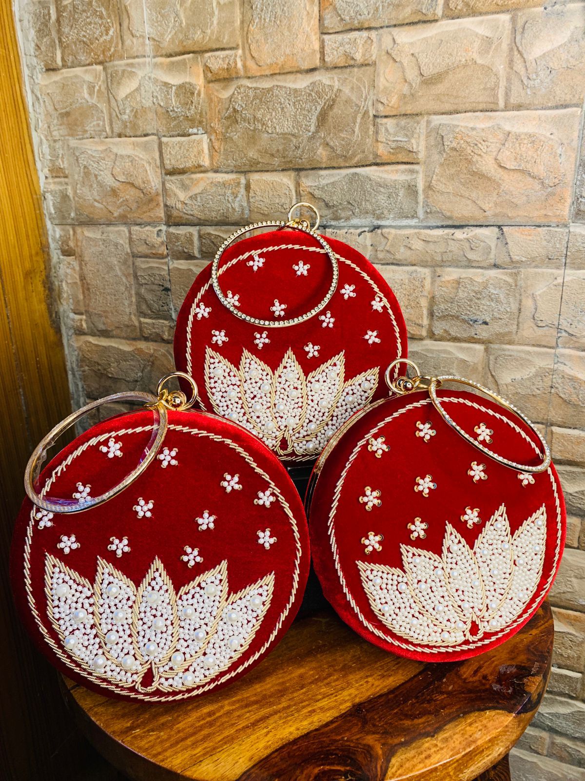 Red round clutch with white lotus beadwork with bangle