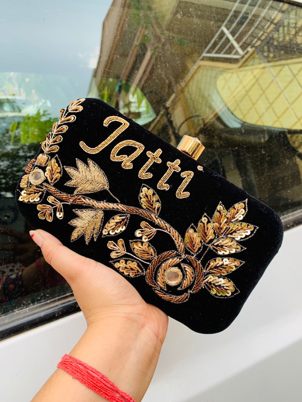 Velvet embroidered clutch with golden work