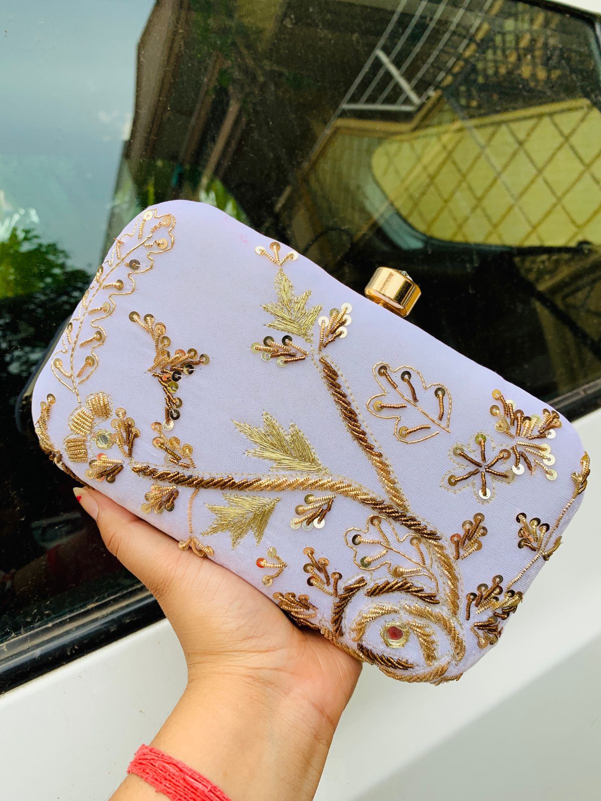 Velvet embroidered clutch with golden work