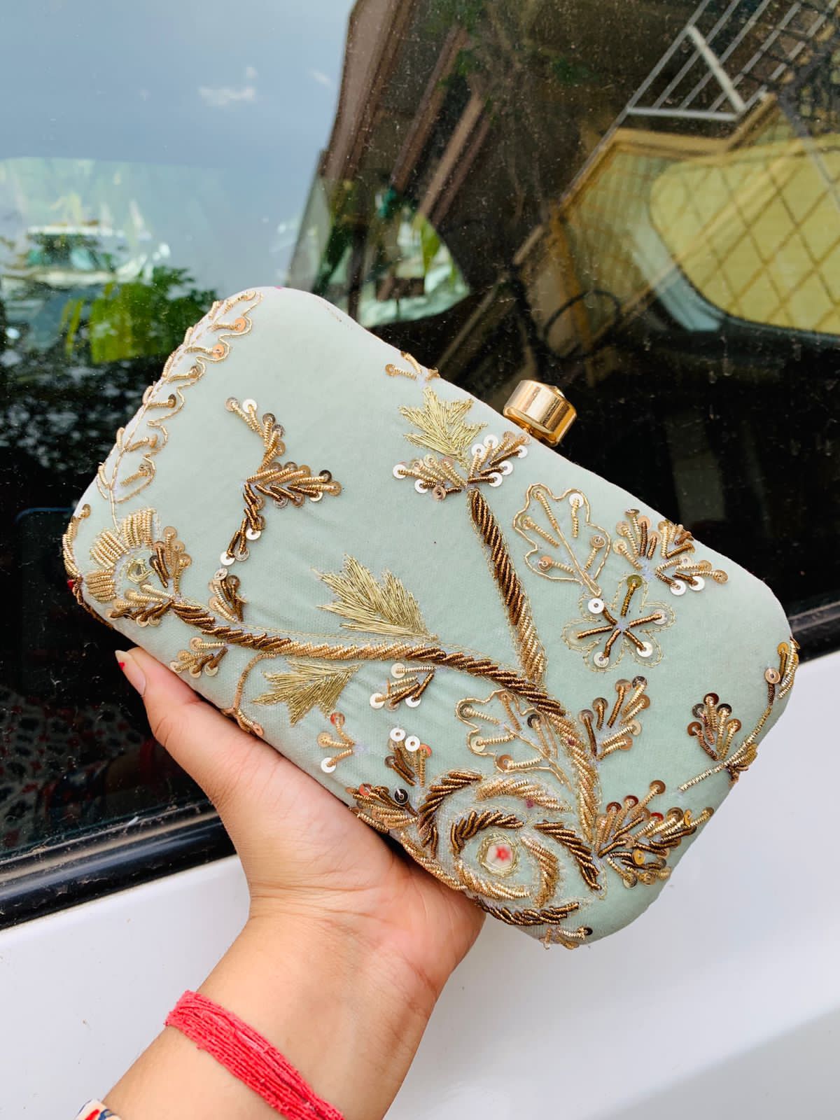 Velvet embroidered clutch with golden work