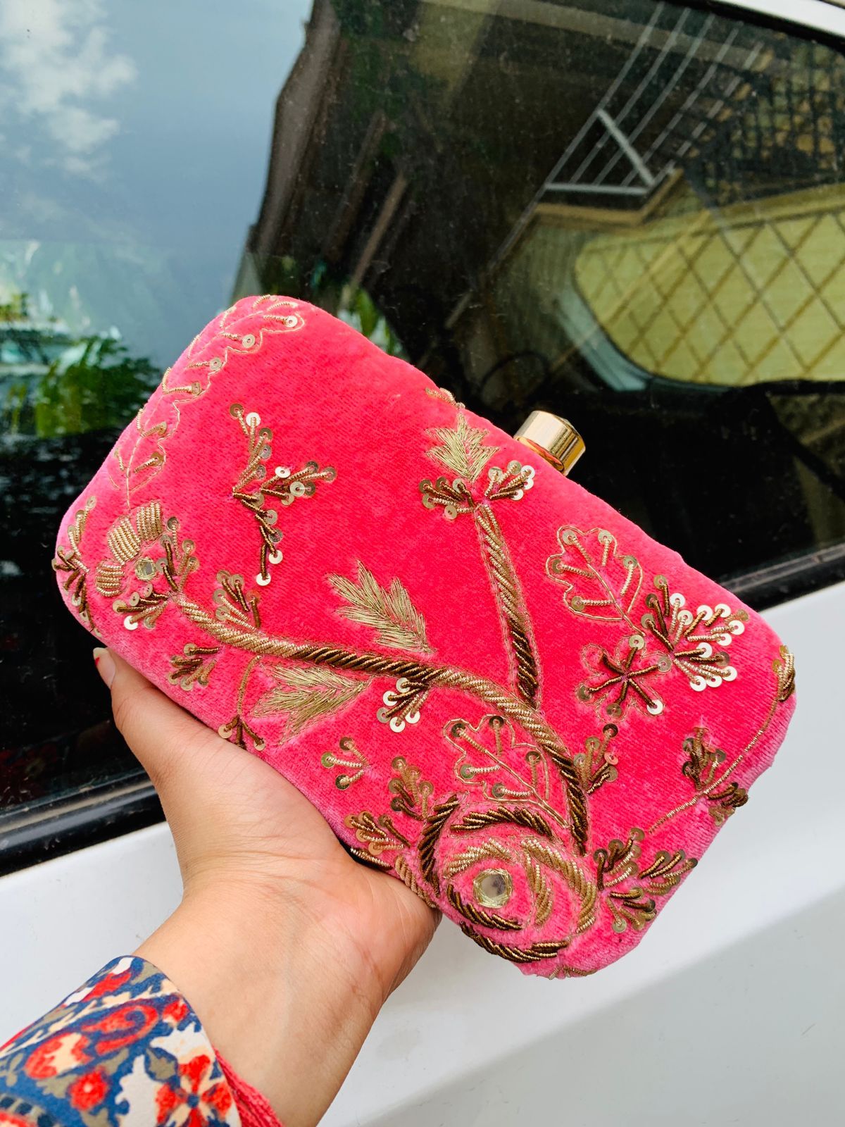 Velvet embroidered clutch with golden work