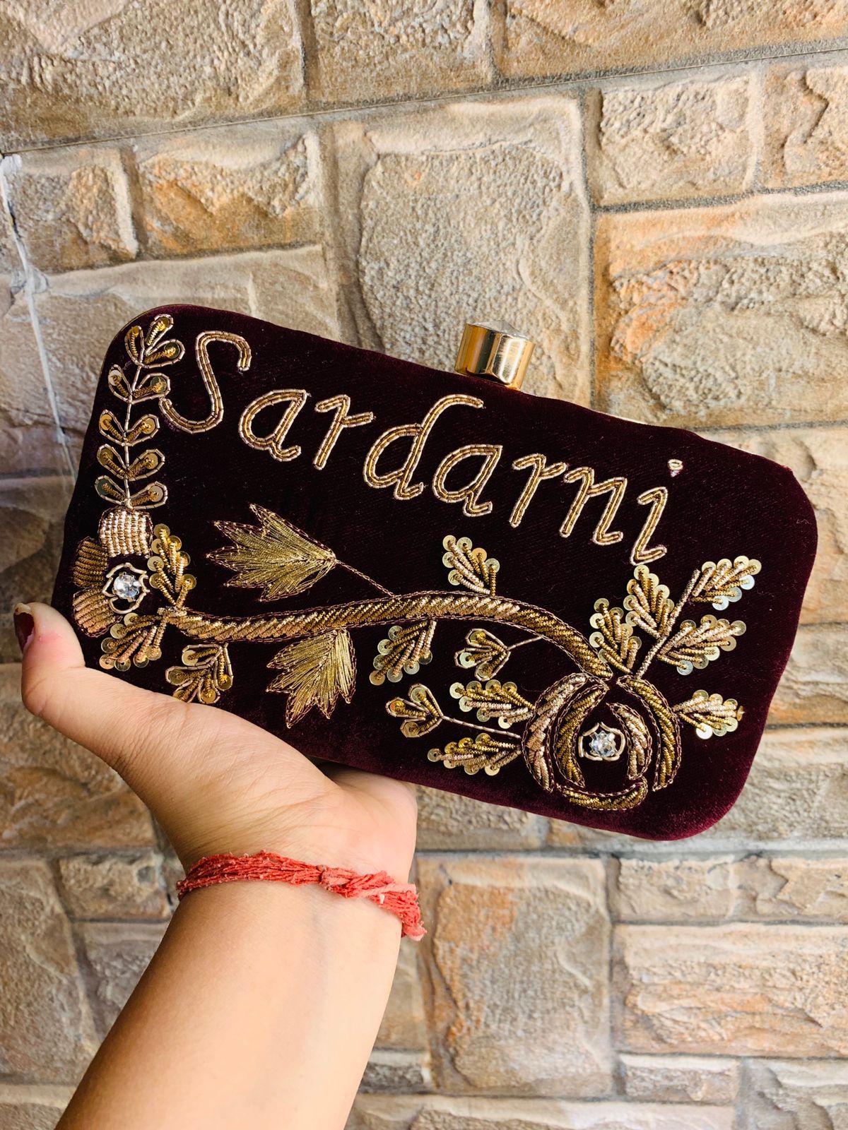 Velvet embroidered clutch with golden work