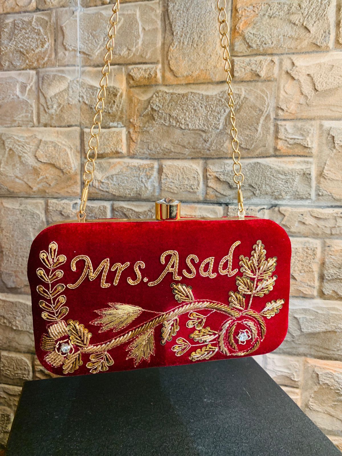 Velvet embroidered clutch with golden work