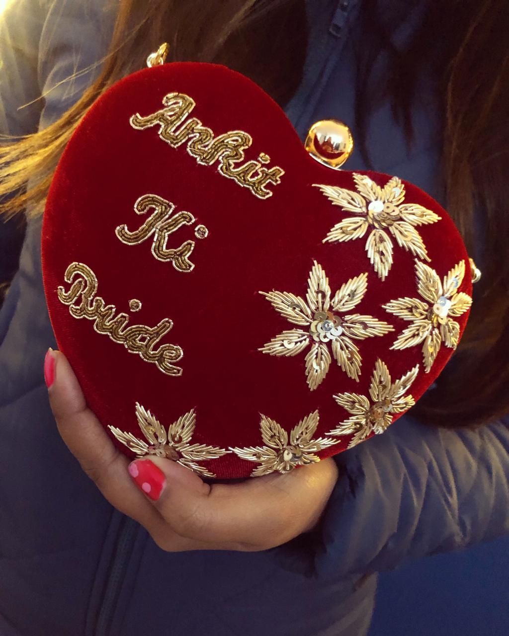 Heart shape embroidered clutch with golden sequins work