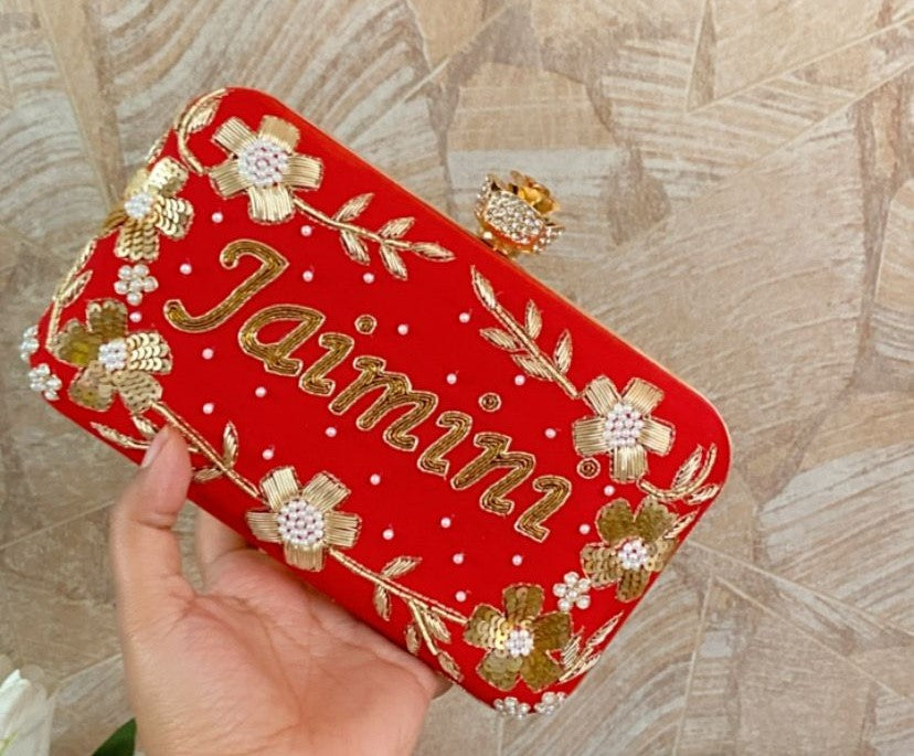 Red clutch with golden floral work