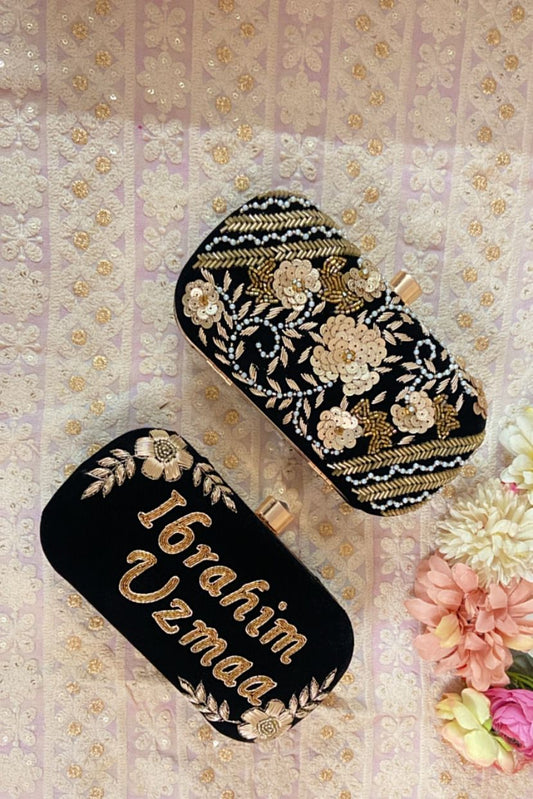 Black clutch with golden piping work