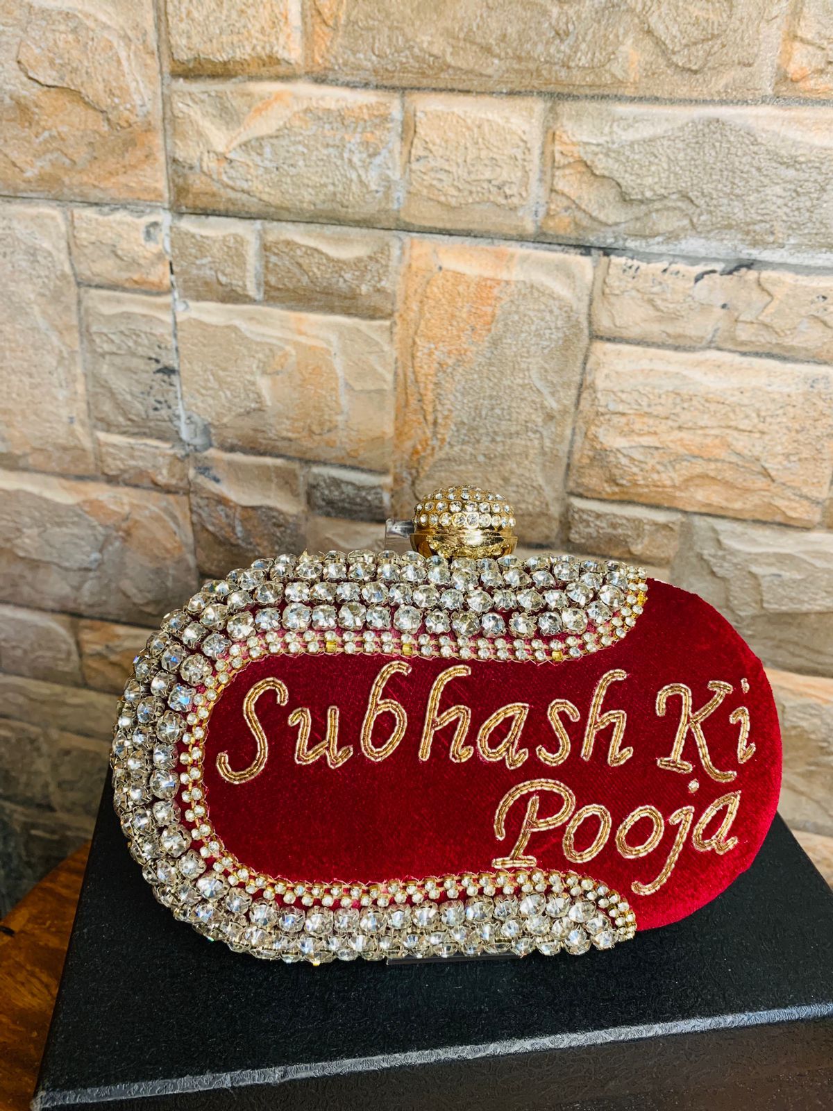 Maroon oval name clutch with stone work