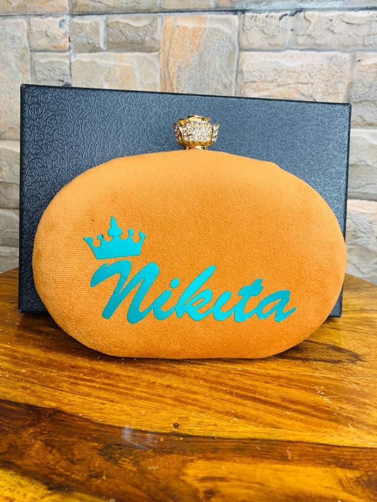 Oval name clutch with designer knob