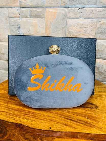 Oval name clutch with designer knob