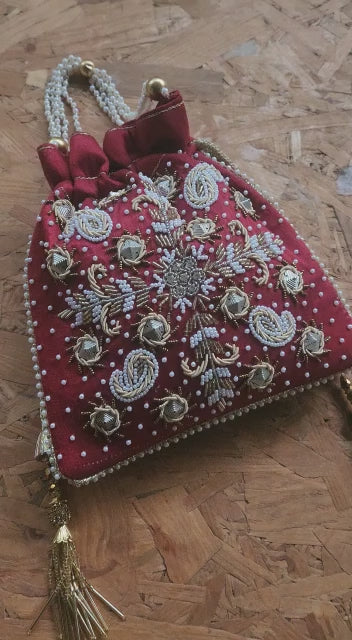 Raw silk fabric potli with zardosi and pearl work