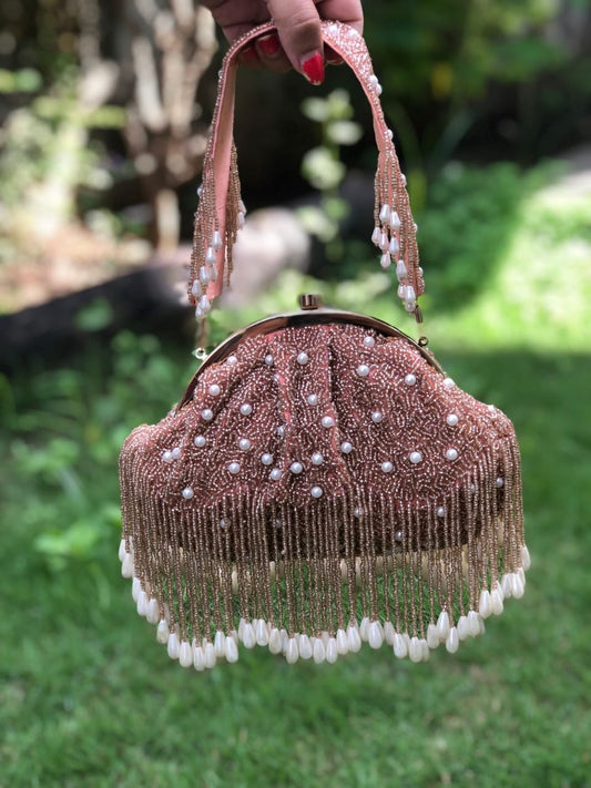 Pink half frame pearl potli bag with tassels