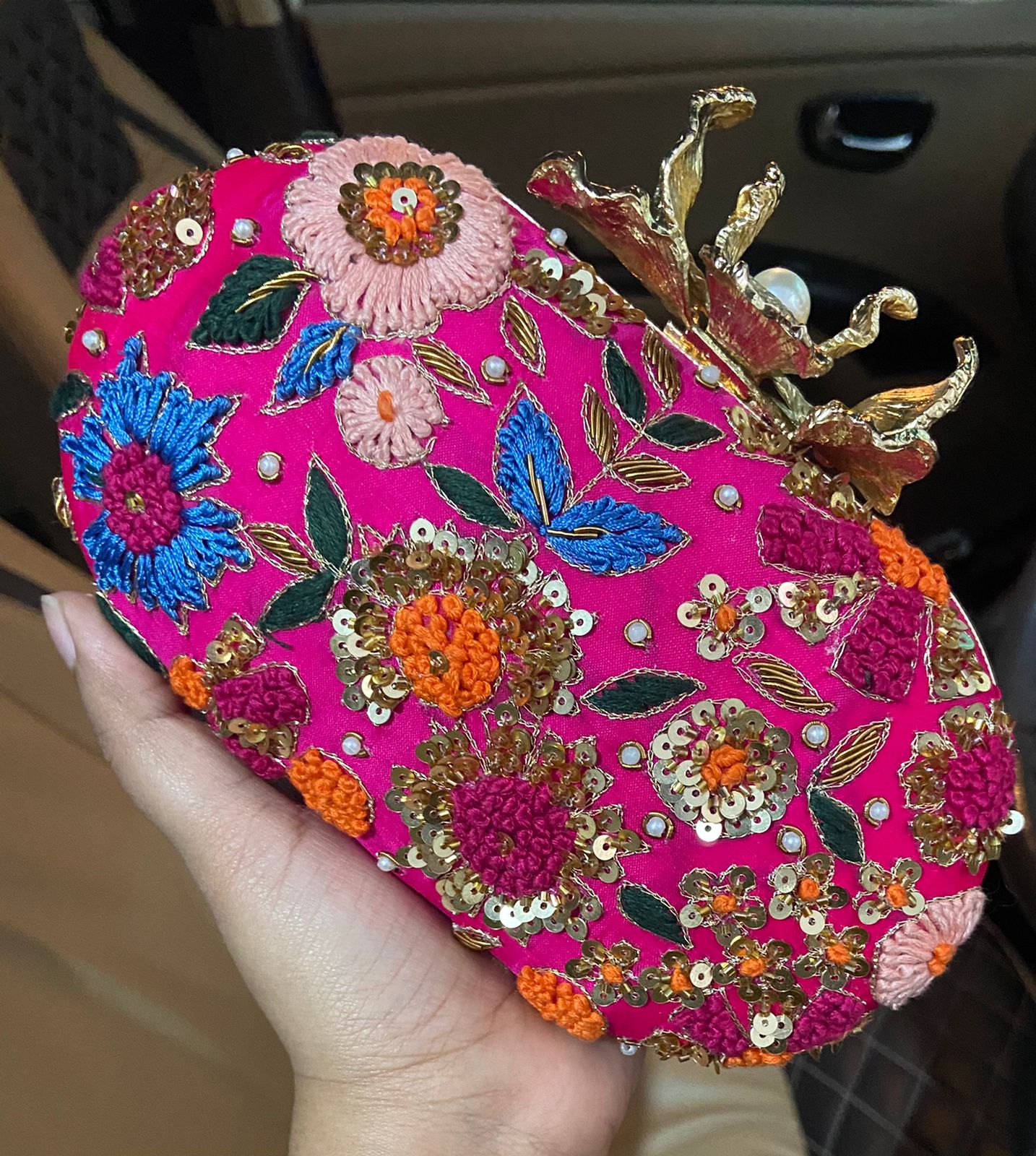 Pink embroidered oval clutch with designer flower knob