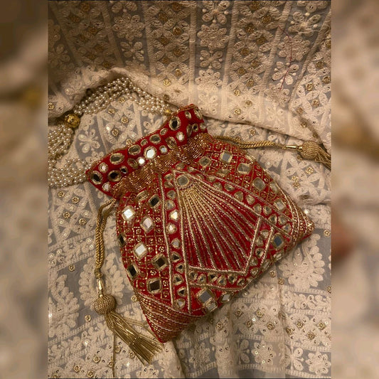 Red potli bag with golden thread and mirror work