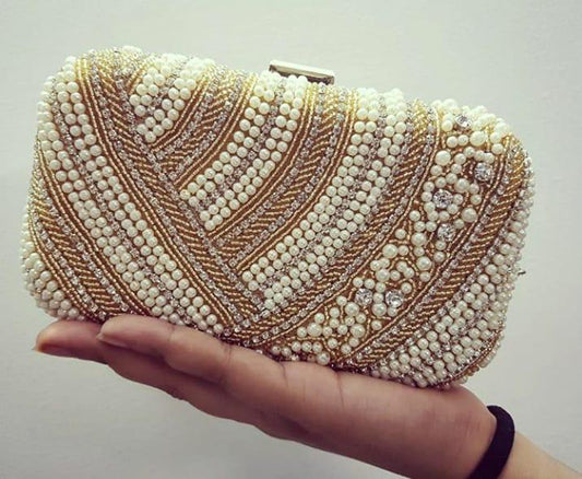 Dual tone pearl work clutch with golden piping work