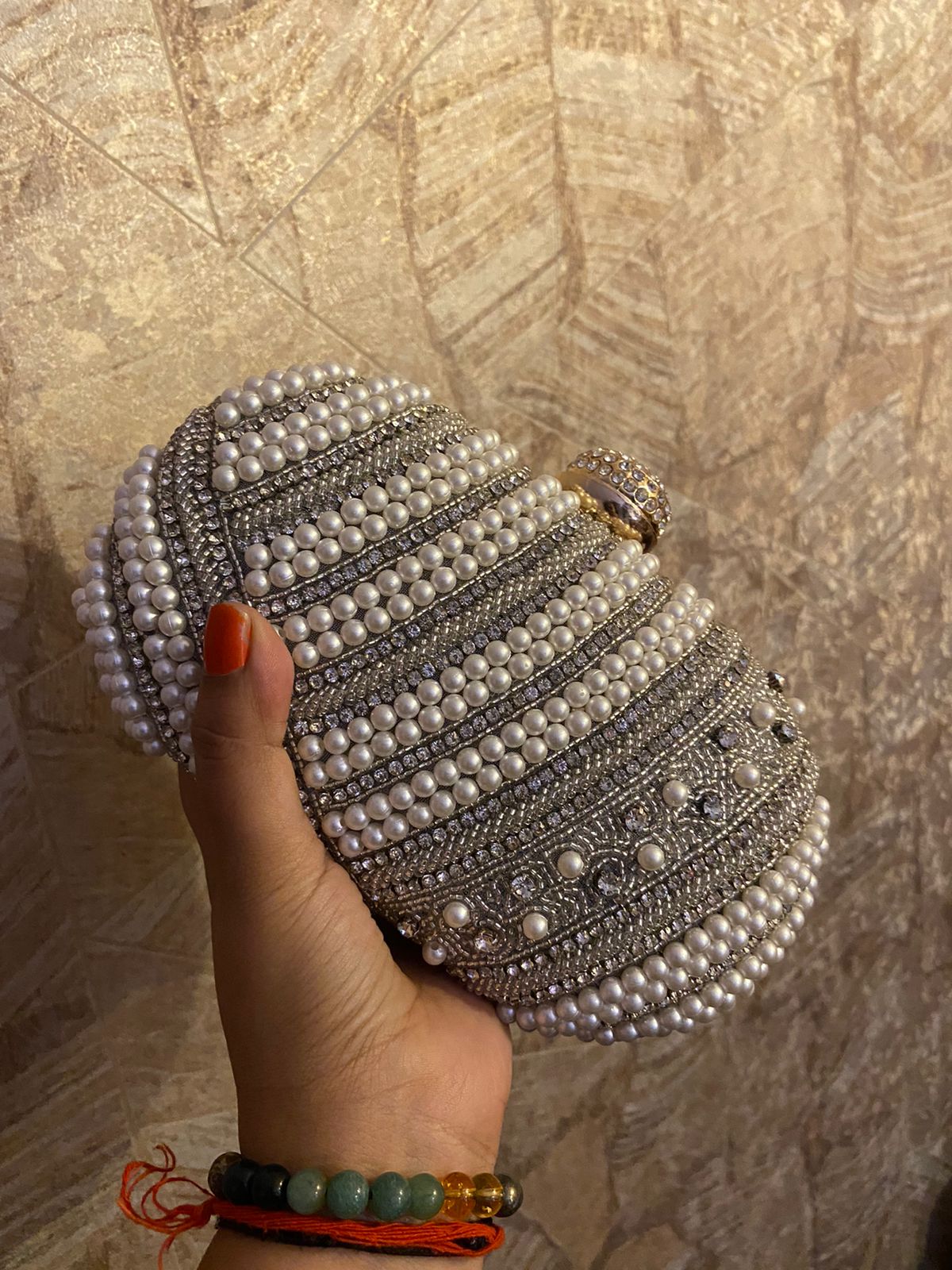 White and silver bead work oval clutch