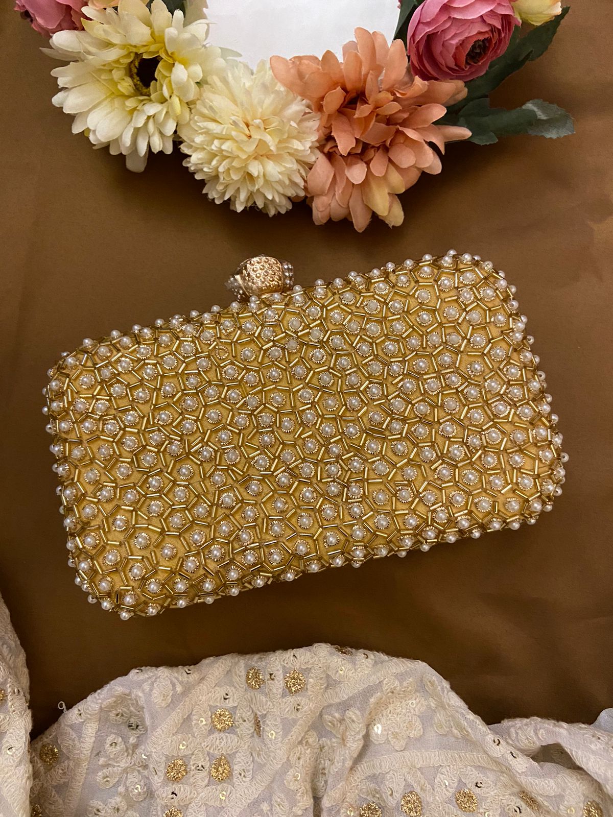 Golden clutch with pearl work & designer knob