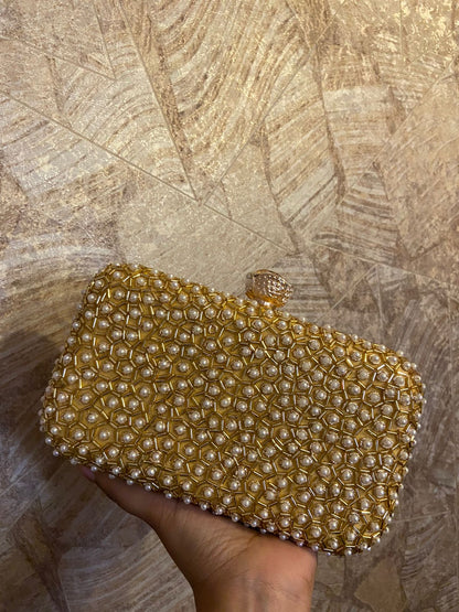 Golden clutch with pearl work & designer knob