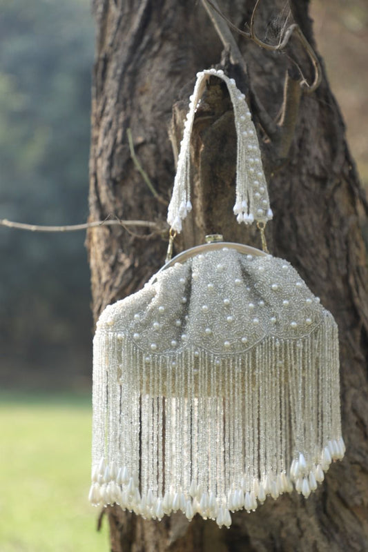 Half frame white pearl potli bag with tassels