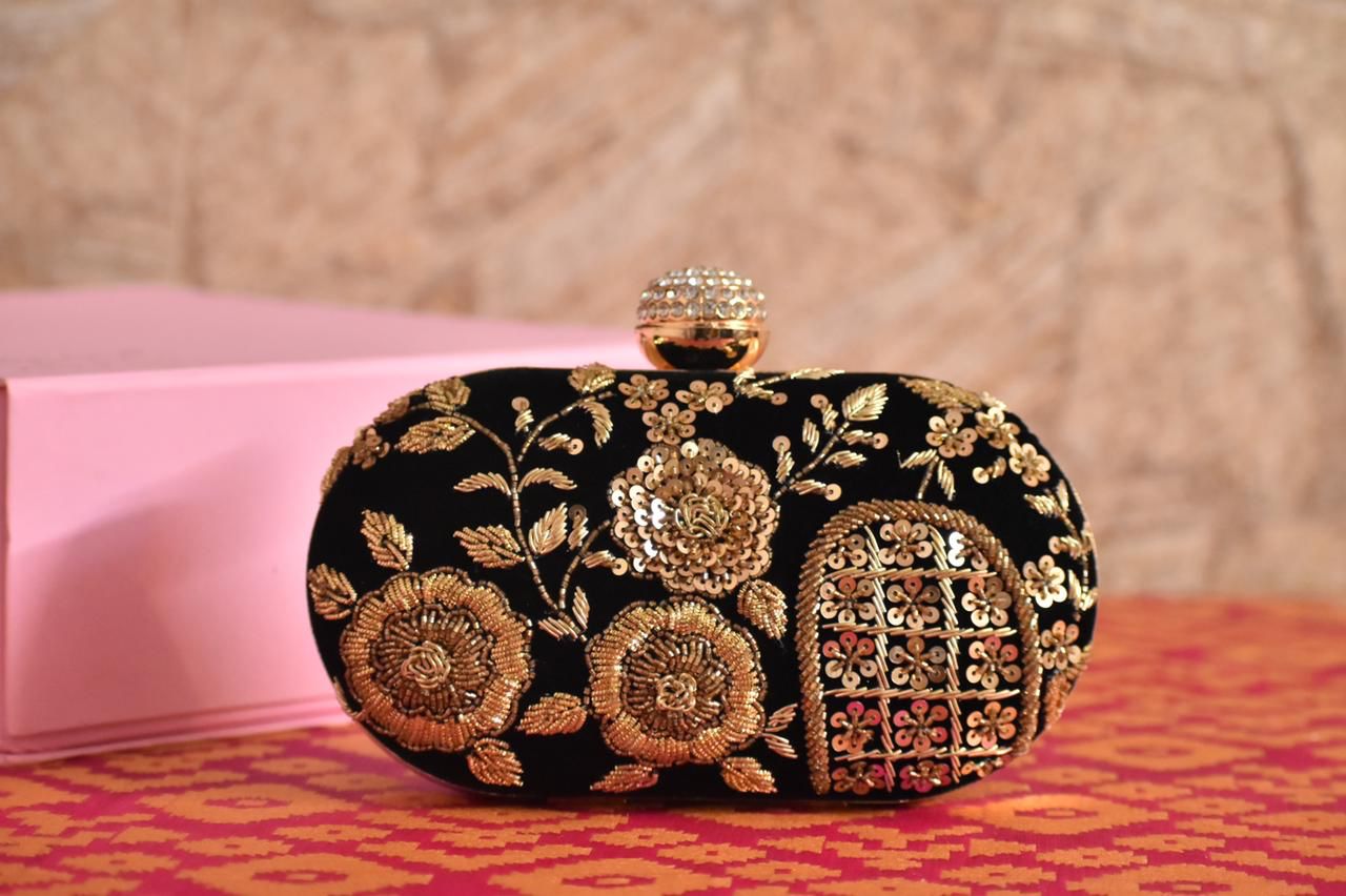 Oval black embroidered clutch with designer knob